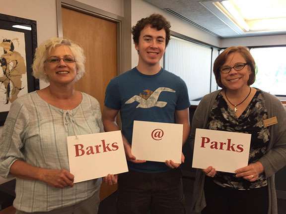 Brendan Finan, pictured center, submitted Barks@Parks, which becomes the official event name in May 2015. Left, Jodi Hilleman then library administrative assistant. Right, Monica Gillen.
