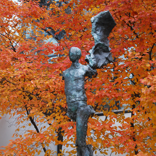 Color image with fall background of Left Side Angel sculpture