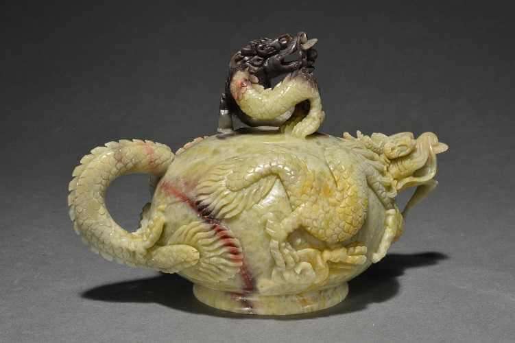 Light yellow-ish jade carved teapot with a head as a spout and a tail as a handle with scales on the sides