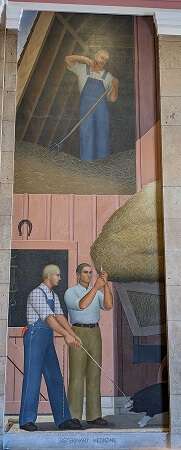 Tall mural painting of 3 white men: 1 is wiping sweat from his chin while moving hay in the upper part of a bar, 1 in overalls and checkered shirt is holding a black pick with white feet, while a 1 in a collared shirt and dress pants prepares a syringe