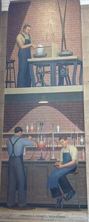 Tall mural showing three white men on two levels of an indoor brick building. 1 on the upper-level is forming a vase on a complex mechanical table which includes a spinner. On the lower level both men have approns and 1 has his back turned pouring chemicals into a beaker, 1 is sitting on stool writing something in a small notebook.