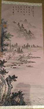 Long scroll with Chinese text at top showing trees on the left in the foreground, the edges of a body of water in the middle-ground, and mountains surrounded by fog at the top in the background