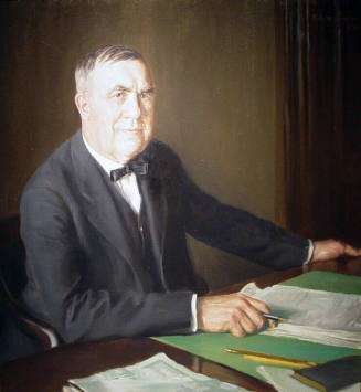 Portrait of H. Knapp, seated at desk with papers in front of him